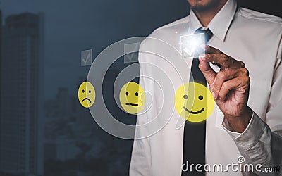 Businessman hand with pen pressing smiley face emoticon on virtual touch screen.good feedback rating and positive customer review Stock Photo