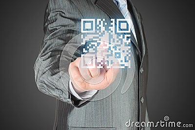 Businessman with hand pressing virtual qr code Stock Photo