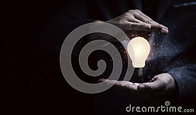 Businessman hand protecting lightbulb glowing with connection line for creative thinking ideas and innovation concept Stock Photo