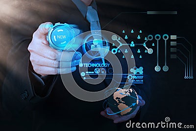 Businessman hand pushing new technology button on modern comput Stock Photo