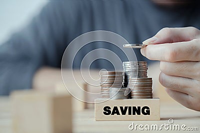 Businessman hand putting coin stack for saving money, budget, investment or strategy for personal saving, concept saving money for Stock Photo