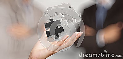 Businessman hand showing 3d puzzle Stock Photo