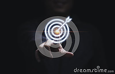 Businessman hand touching to target dart board for setup and achievement objectives target for business investment concept Stock Photo