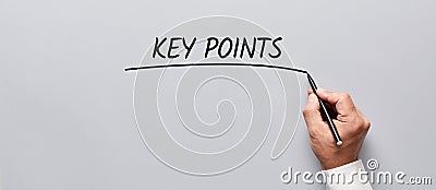 Businessman hand underlining the word key points on gray background. Highlighting the key points of an issue in business Stock Photo