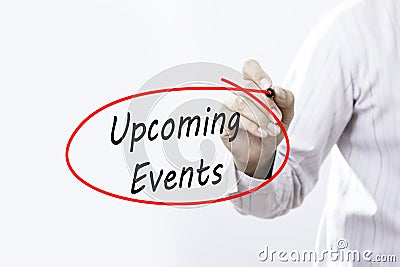 Businessman Hand Writing Upcoming Events with a marker over tran Stock Photo