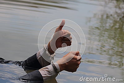 Businessman was arrested by handcuffs and drowning Stock Photo