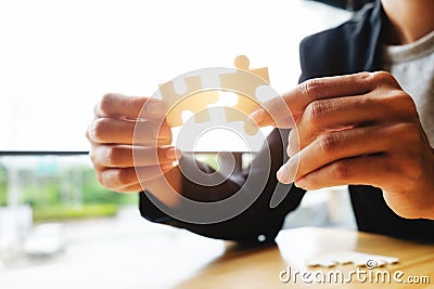 Businessman hands connecting jigsaw puzzle Stock Photo