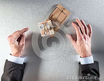 Businessman hands showing hesitation facing euro money in mouse trap Stock Photo