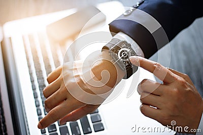 Businessman hands touching smart watch. Using a compass app Stock Photo