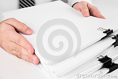 Businessman hands working in stacks of paper files for searching information business and financial concept Stock Photo