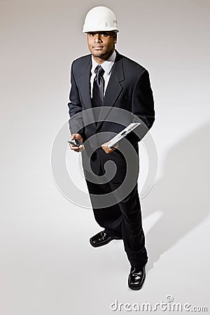 Businessman in hard-hat with walkie-talkie Stock Photo