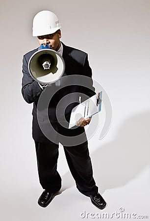 Businessman in hard-hat with walkie-talkie Stock Photo