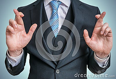 Businessman has crossed fingers behind his back. Good luck or dishonesty concept Stock Photo