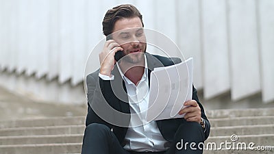 Businessman having conversation on smartphone. Executive analyzing diagrams Stock Photo