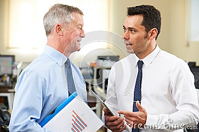 Businessman Having Discussion With Senior Mentor In Office Stock Photo