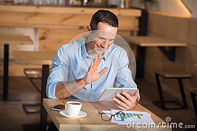 Businessman having videochat using digital tablet Stock Photo