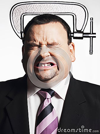 Businessman With Head In Vice Stock Photo