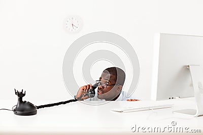 Businessman hiding behind desk Stock Photo