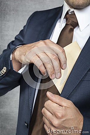 Businessman hiding bribes Stock Photo