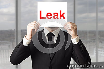 Businessman hiding face behind sign leak Stock Photo