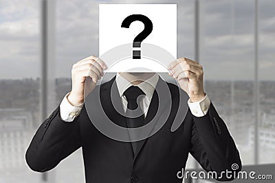 Businessman hiding face behind sign question mark Stock Photo