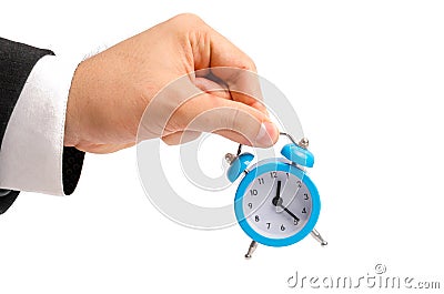 A businessman is holding an alarm clock. Watch in hand. The concept of hourly pay, time. Late for work. Full or incomplete rate. O Stock Photo