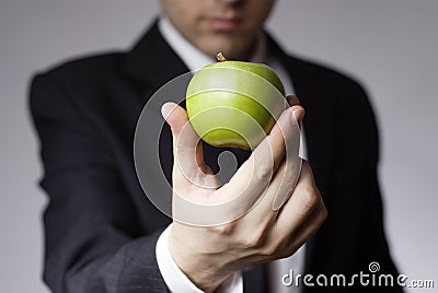 Businessman holding apple Stock Photo