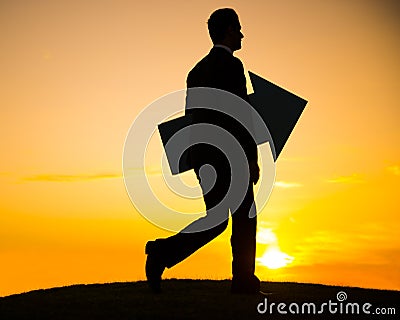 Businessman holding the arrow and keep walking Stock Photo