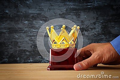 Businessman holding award trophy for show victory or winning first place Stock Photo