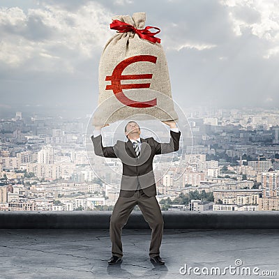 Businessman holding big moneybag with euro sign Stock Photo