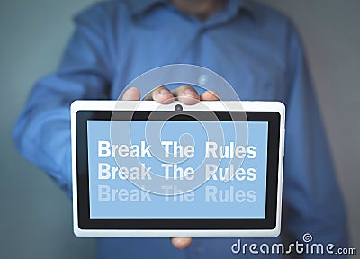 Businessman holding Break The Rules word on a tablet screen. Stock Photo
