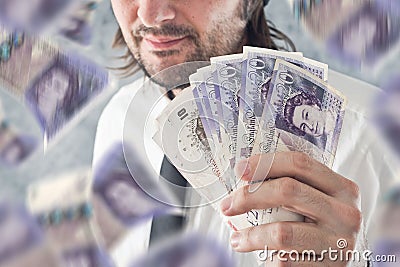 Businessman holding British pounds money, bnknotes falling from Editorial Stock Photo