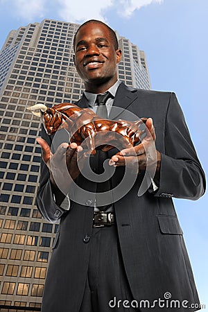 Businessman Holding Bull Stock Photo