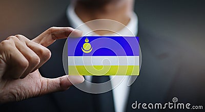 Businessman Holding Card of Buryatia Flag Stock Photo