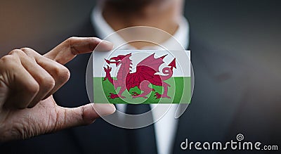 Businessman Holding Card of Wales Flag Stock Photo