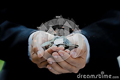 Businessman holding coins with arrow up to 2024 in financial concepts and financial investment business stock growth.Planning, Stock Photo