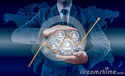 Businessman holding a concept of the increase and growth of statistics in business Stock Photo