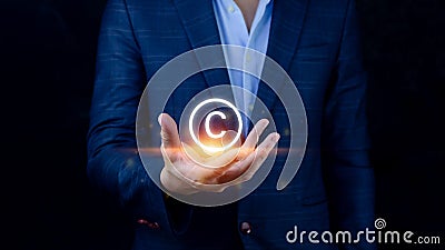 Businessman holding Copyright icon, patents and intellectual property protection law and rights. with symbol of the copyright. Stock Photo