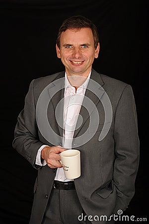 Businessman holding cup Stock Photo