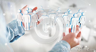 Businessman holding 3D rendering group of people in his hand Stock Photo