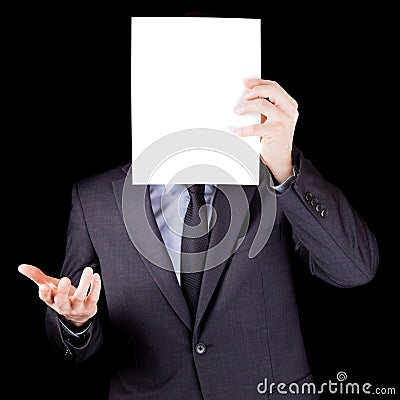 Businessman holding an empty sheet of paper in front of his face Stock Photo