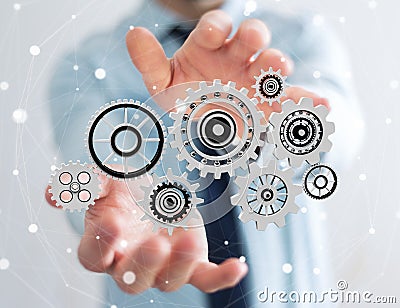 Businessman holding floating gear icons in his hand 3D rendering Stock Photo