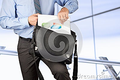 Businessman holding and geting out documents with graphs from Stock Photo