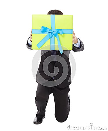 Businessman holding a gift box and kneel down . Stock Photo