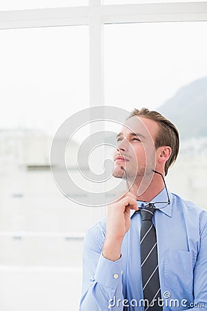 Businessman holding glasses in day dreaming Stock Photo