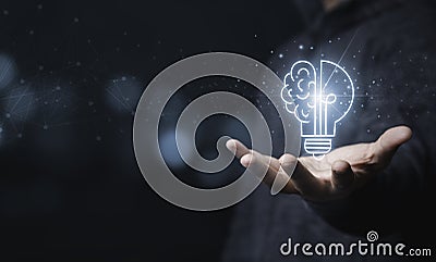 Businessman holding half of virtual lightbulb and brain on blue bokeh background , Smart thinking idea and inspiration innovation Stock Photo