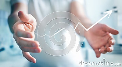 Businessman holding hand-drawn arrow going up Stock Photo