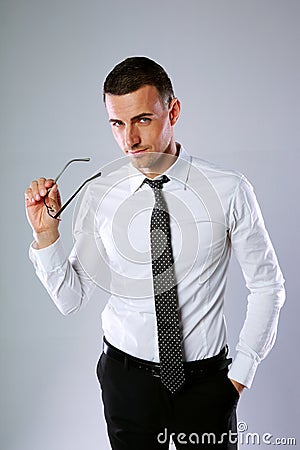 Businessman holding his glasses Stock Photo