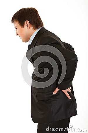 Businessman holding his hand at his aching back Stock Photo