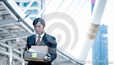 Businessman holding holding cardboard box with personal belongings Leaving Job. Fired Stock Photo